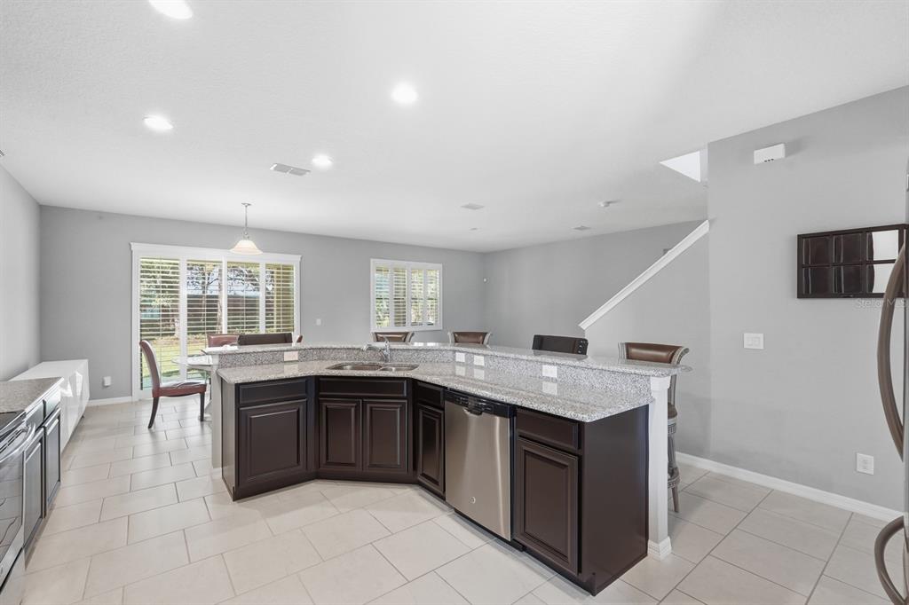 1457 Osprey Ridge Drive Eustis, FL 32736 - Photo 8 of 54 a kitchen with a stove sink and cabinets