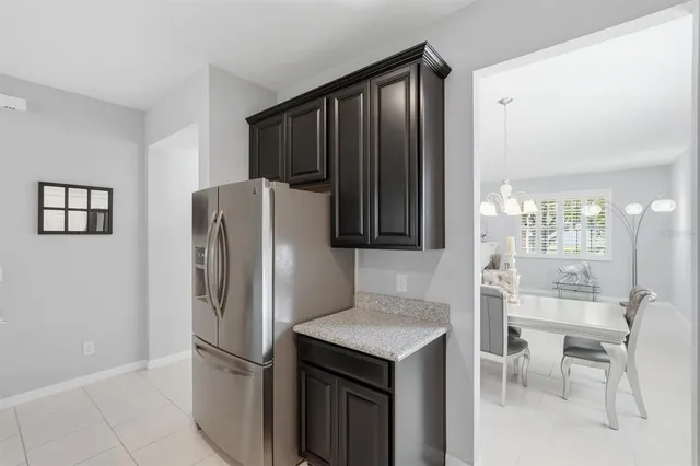 a kitchen with stainless steel appliances granite countertop a refrigerator and a stove