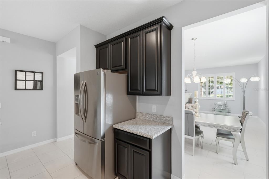 1457 Osprey Ridge Drive Eustis, FL 32736 - Photo 10 of 54 a kitchen with stainless steel appliances granite countertop a refrigerator and a stove