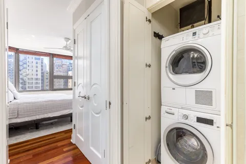 a view of a bedroom with washer and dryer