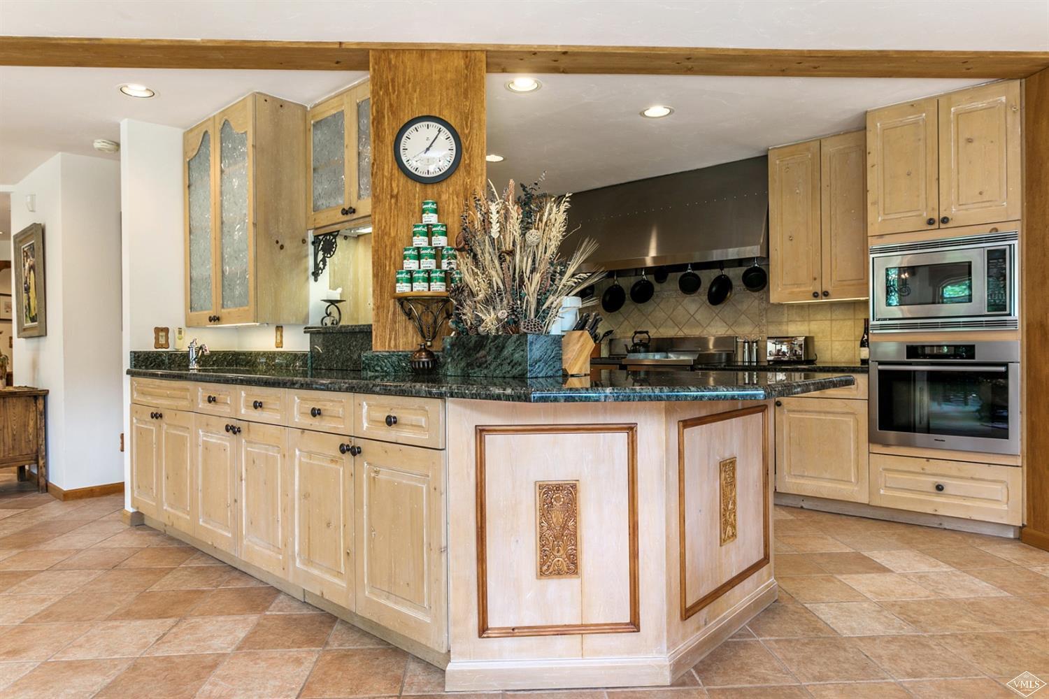 781 Potato Patch Drive Vail, CO 81657 - Photo 13 of 39 a kitchen with stainless steel appliances granite countertop a stove a sink and a microwave