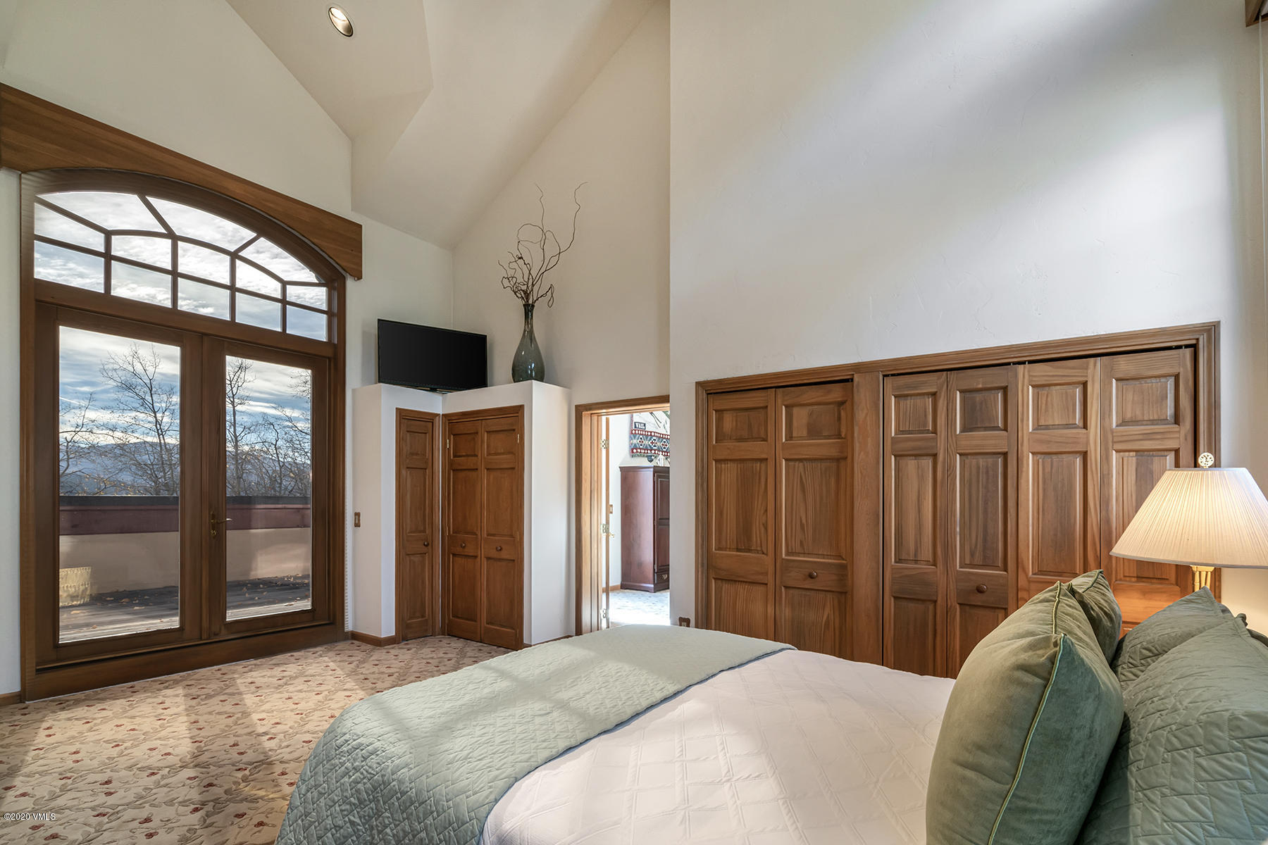 781 Potato Patch Drive Vail, CO 81657 - Photo 17 of 39 a bedroom with a bed closet and a large window