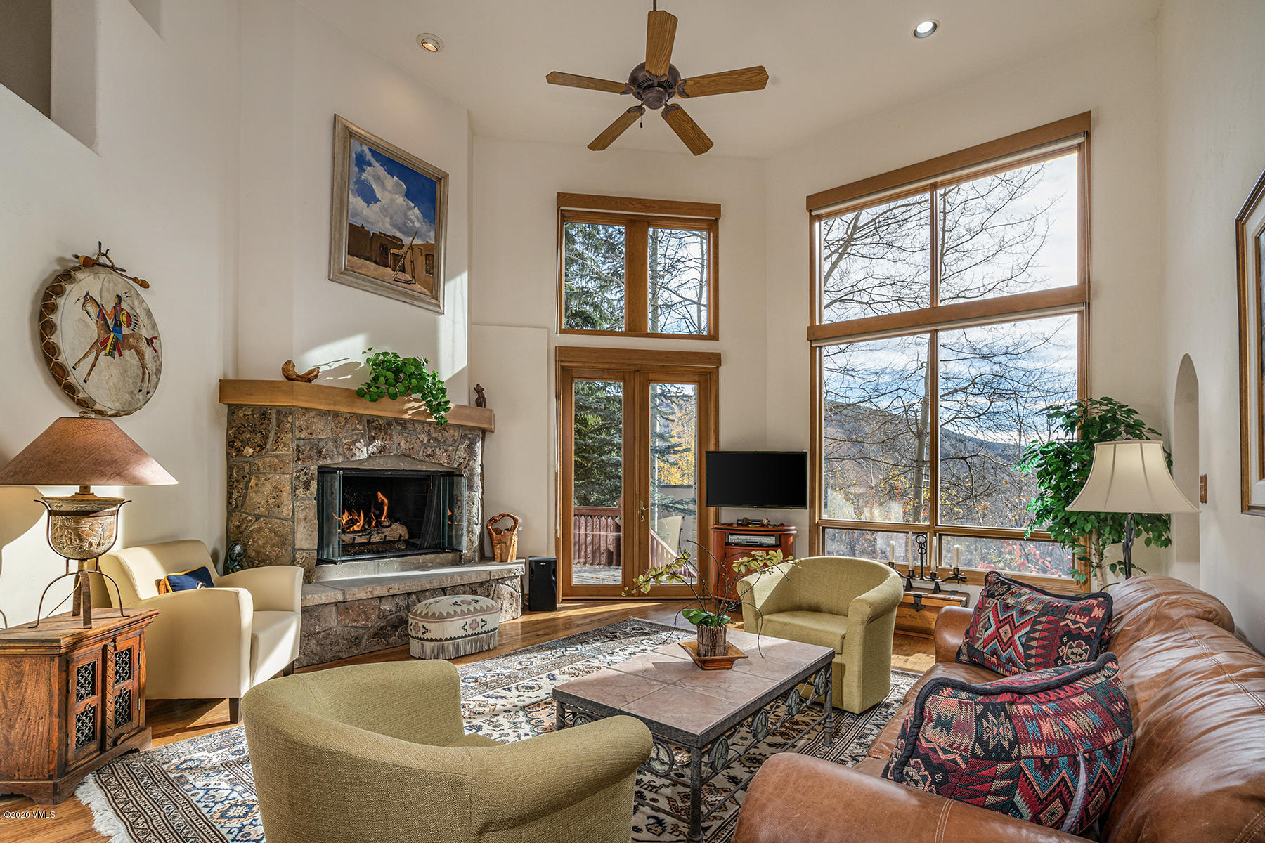 781 Potato Patch Drive Vail, CO 81657 - Photo 29 of 39 a living room with furniture a window and a fireplace