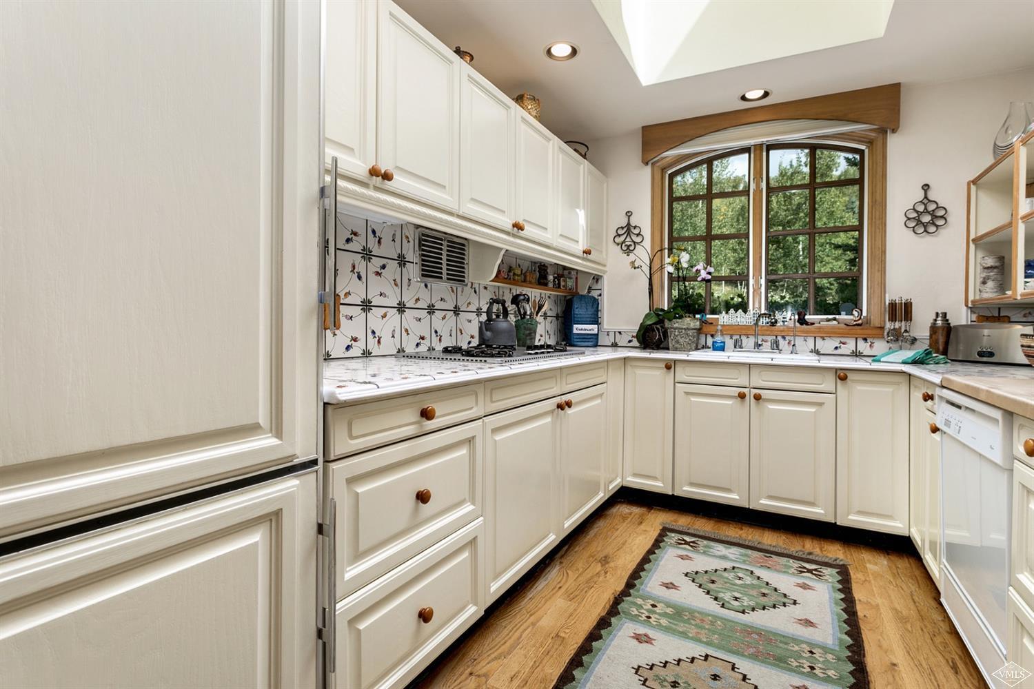 781 Potato Patch Drive Vail, CO 81657 - Photo 35 of 39 a kitchen with granite countertop white cabinets and white appliances