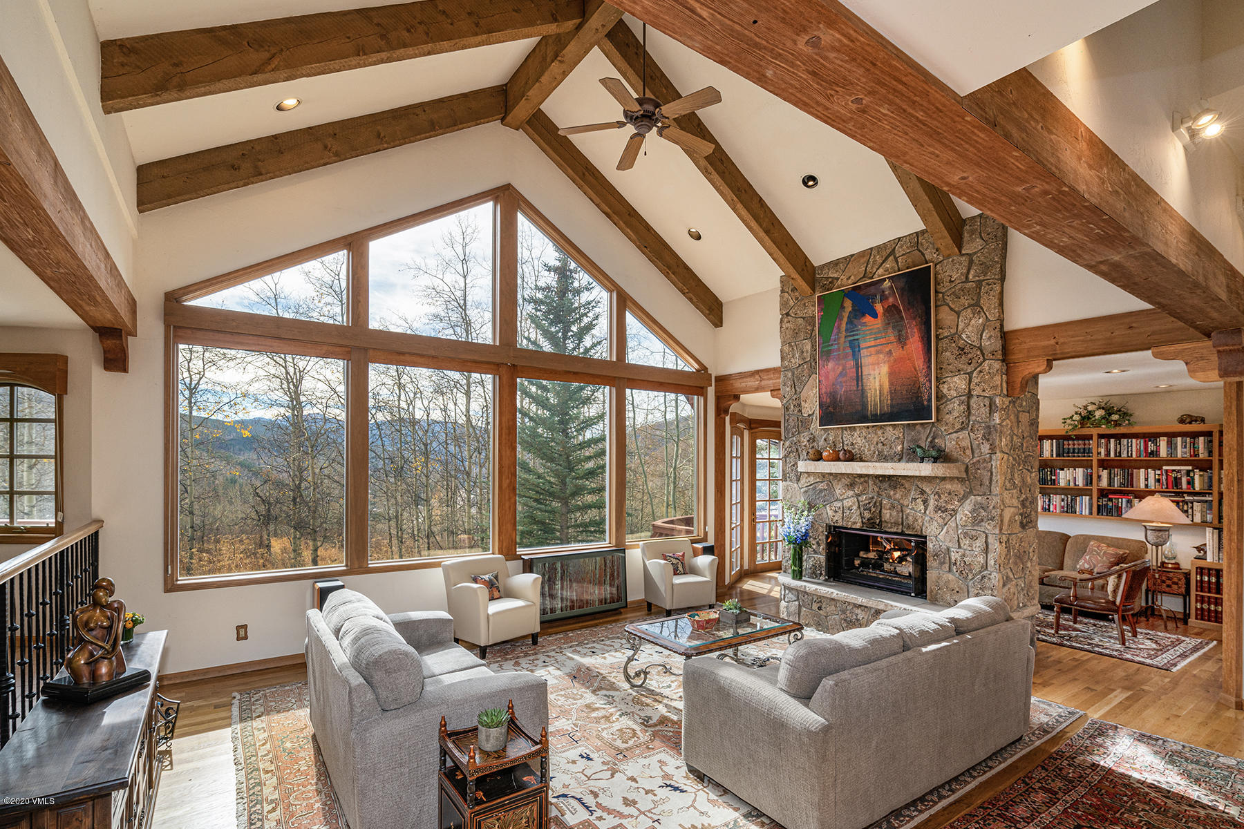 781 Potato Patch Drive Vail, CO 81657 - Photo 10 of 39 a living room with furniture a fireplace and a floor to ceiling window