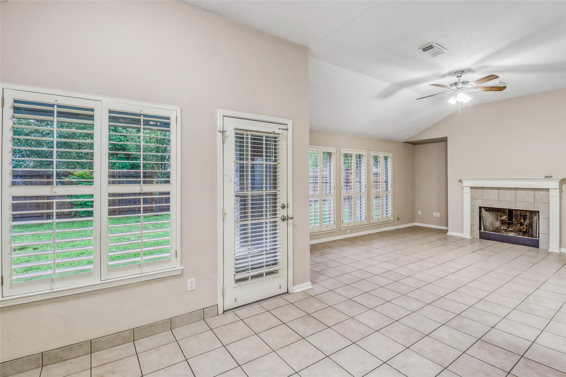 7215 Pembrough Lane Katy, TX 77494 - Photo 12 of 20 a view of an empty room with window and fire place