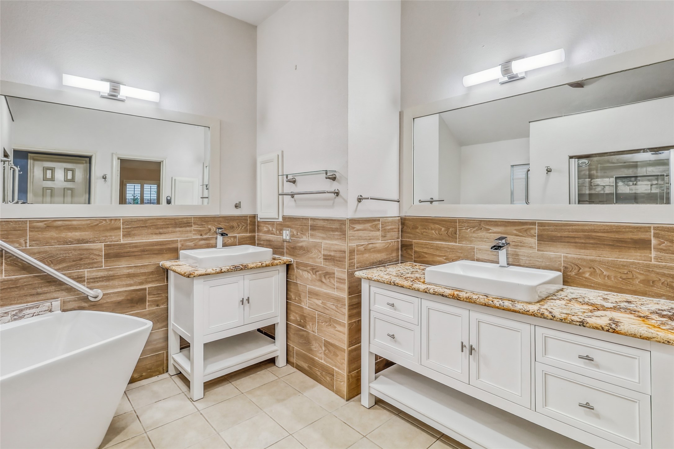 7215 Pembrough Lane Katy, TX 77494 - Photo 17 of 20 a spacious bathroom with a granite countertop sink a toilet mirror and bathtub