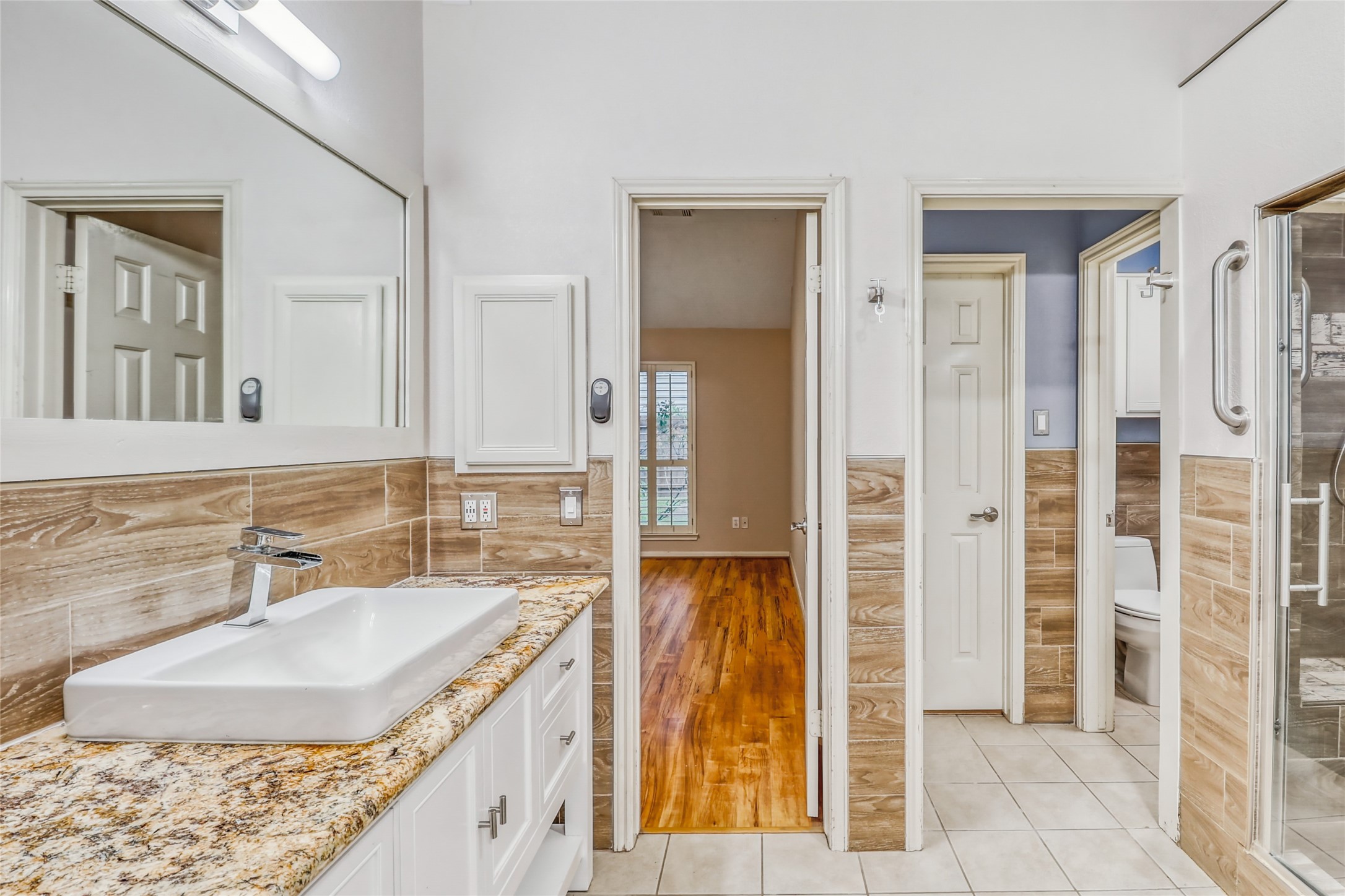 7215 Pembrough Lane Katy, TX 77494 - Photo 18 of 20 a bathroom with a granite countertop sink and a mirror