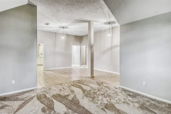 a view of a big room with wooden floor and bathroom