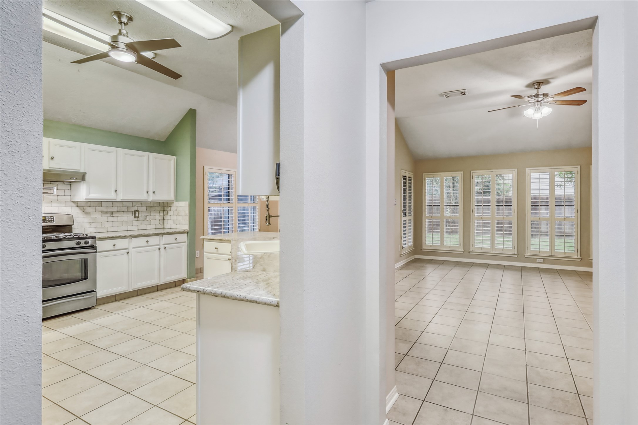 7215 Pembrough Lane Katy, TX 77494 - Photo 7 of 20 a large white kitchen with a stove a sink and a refrigerator