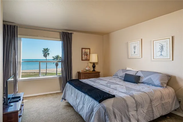 a bedroom with a large bed and a window