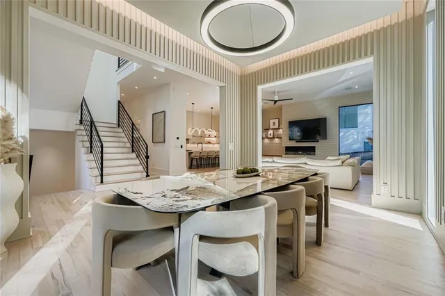 a dining room with furniture and wooden floor