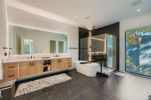 a large white kitchen with a stove a sink dishwasher and a refrigerator