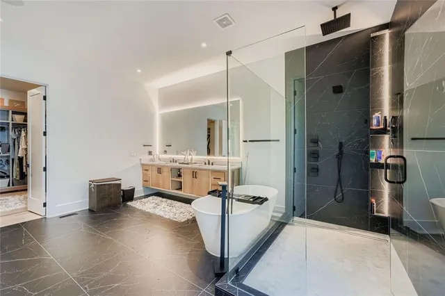 a bathroom with a tub and a shower