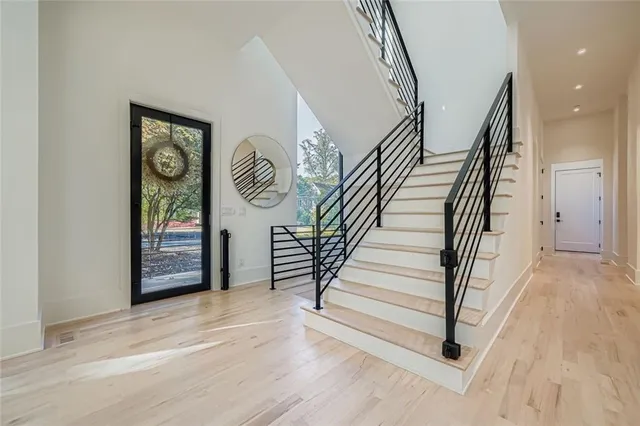 a view of entryway and hall with wooden floor