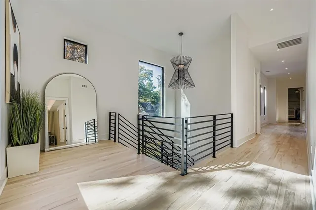 a view of entryway and hall with wooden floor