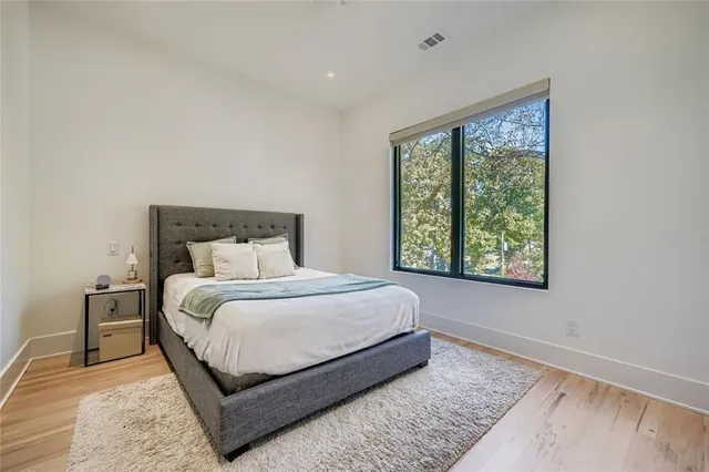a bedroom with a bed lamp and window
