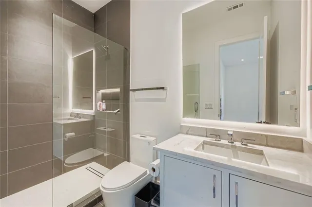 a bathroom with a sink toilet and shower