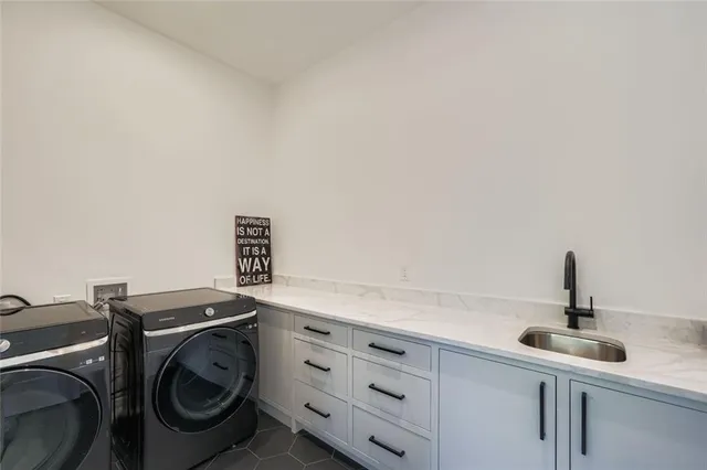 a kitchen with a sink and a washer dryer