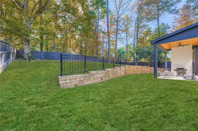 a view of a house with a backyard