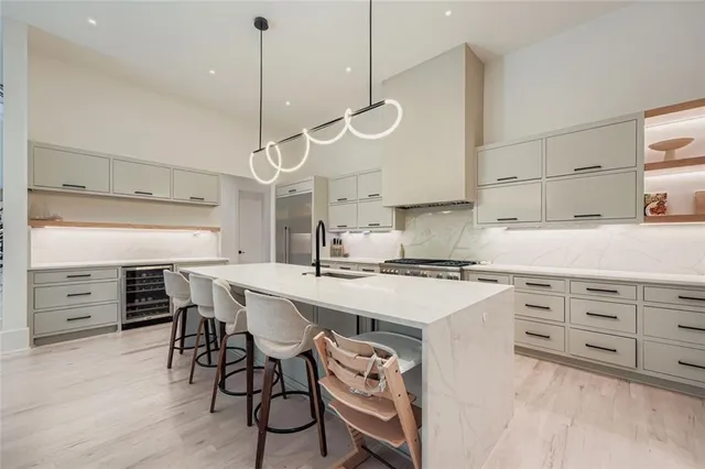 a kitchen with a stove a table and chairs