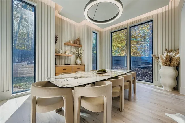 a dining room with furniture a window and wooden floor