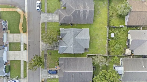 an empty room with chandelier fan