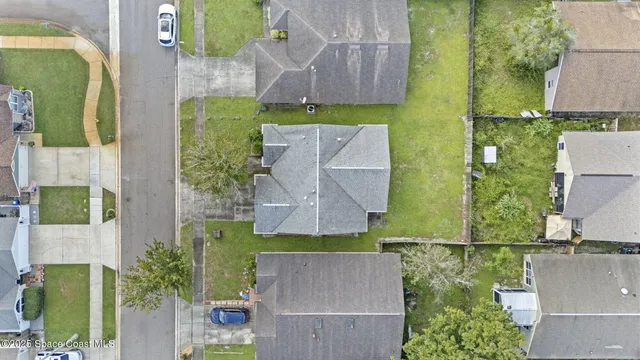 an empty room with chandelier fan