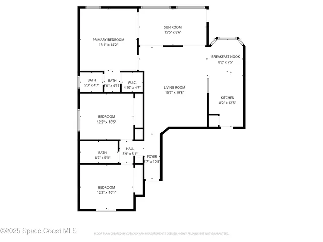 an aerial view of a house with a yard and a large tree