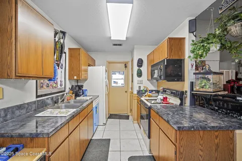 a kitchen with a stove a sink and a microwave
