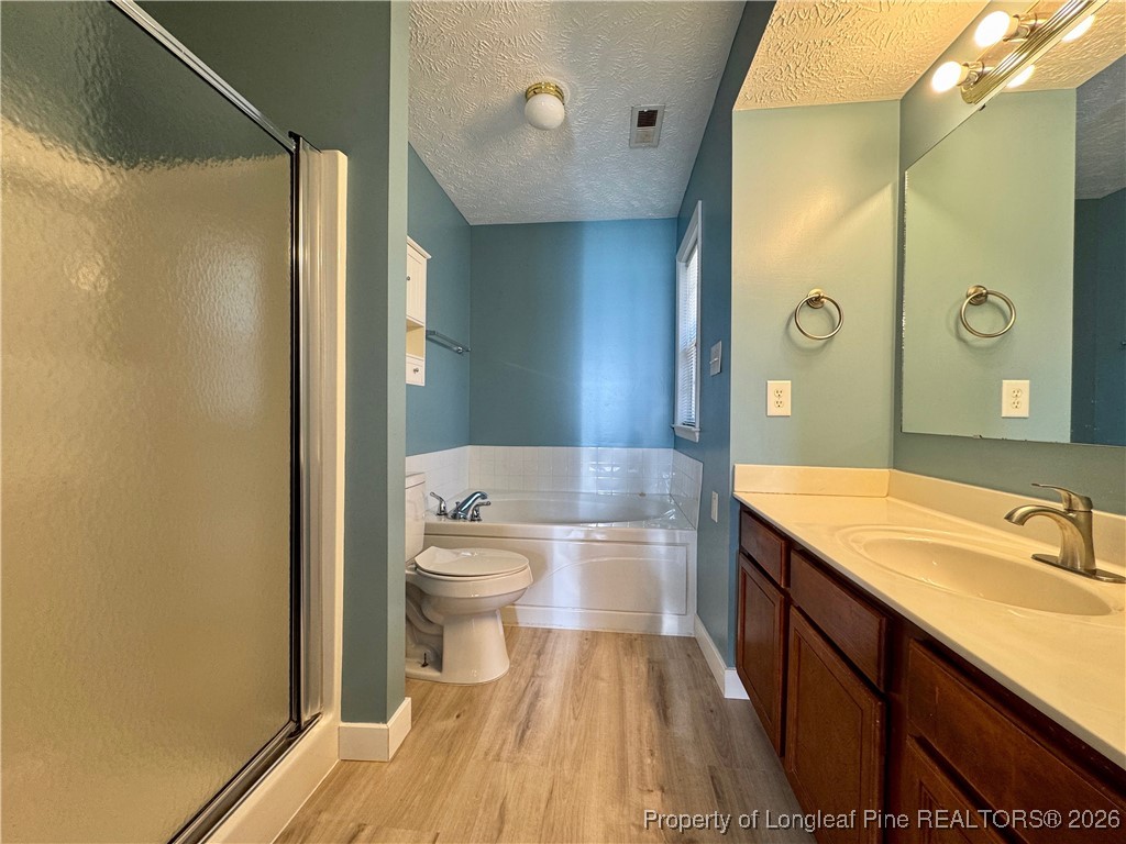 5503 Rising Ridge Drive Hope Mills, NC 28348 - Photo 14 of 18 a bathroom with a sink a toilet and shower