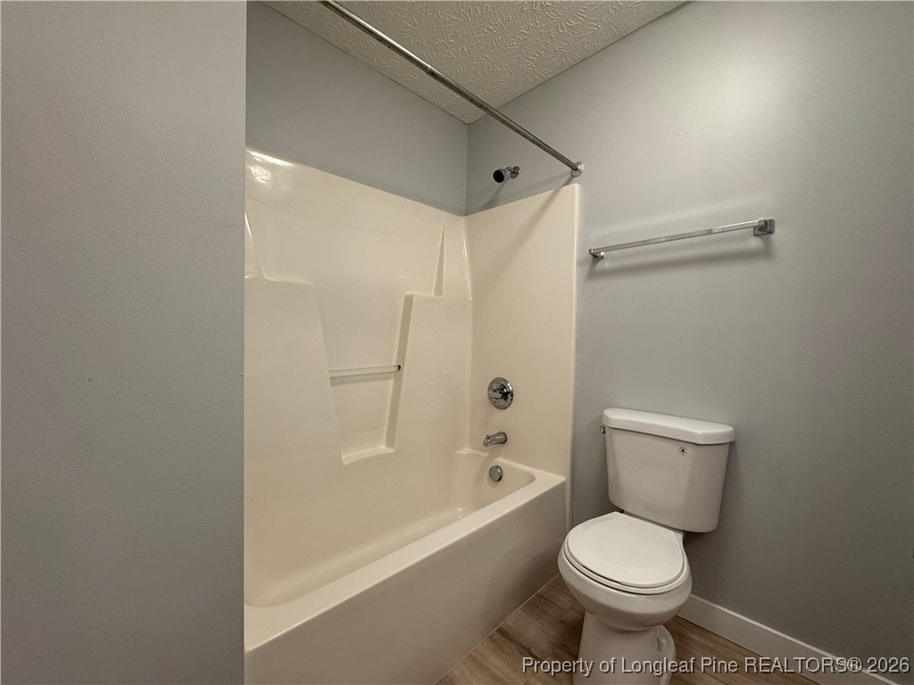 5503 Rising Ridge Drive Hope Mills, NC 28348 - Photo 10 of 18 a bathroom with a toilet and a bathtub