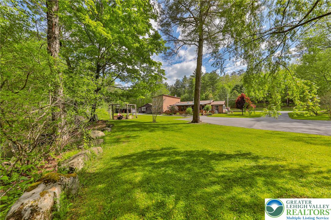 331 Cranberry Creek Road Cresco, PA 18326 - Photo 80 of 95 A spacious grassy lawn introduces a residence nestled amidst verdant trees.