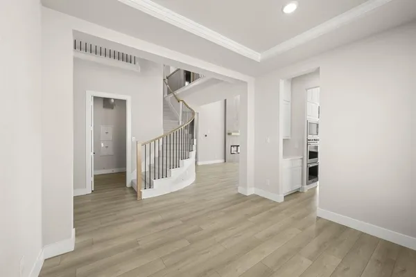 a view of a hallway with wooden floor and entryway