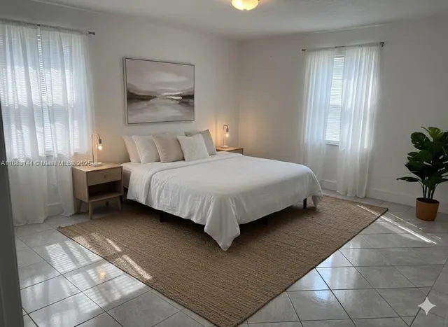 a bed sitting in a bedroom next to a window and a chair