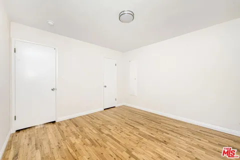 a view of a room with wooden floor