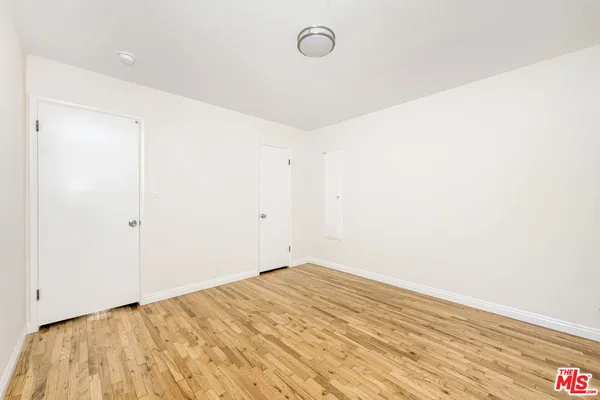 a view of a room with wooden floor