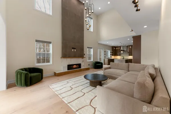 a living room with furniture a flat screen tv and kitchen view