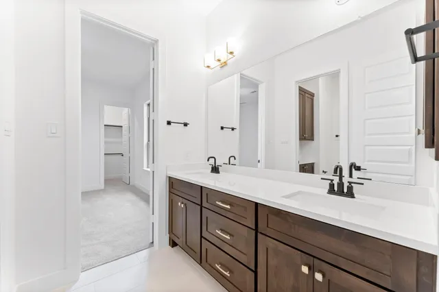 a bathroom with a sink double vanity and a mirror