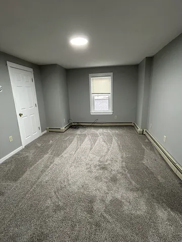 an empty room with a empty space and windows