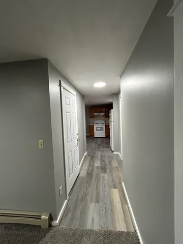 a view of a hallway with wooden floor