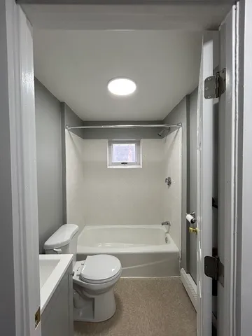 a bathroom with a toilet a sink and bathtub
