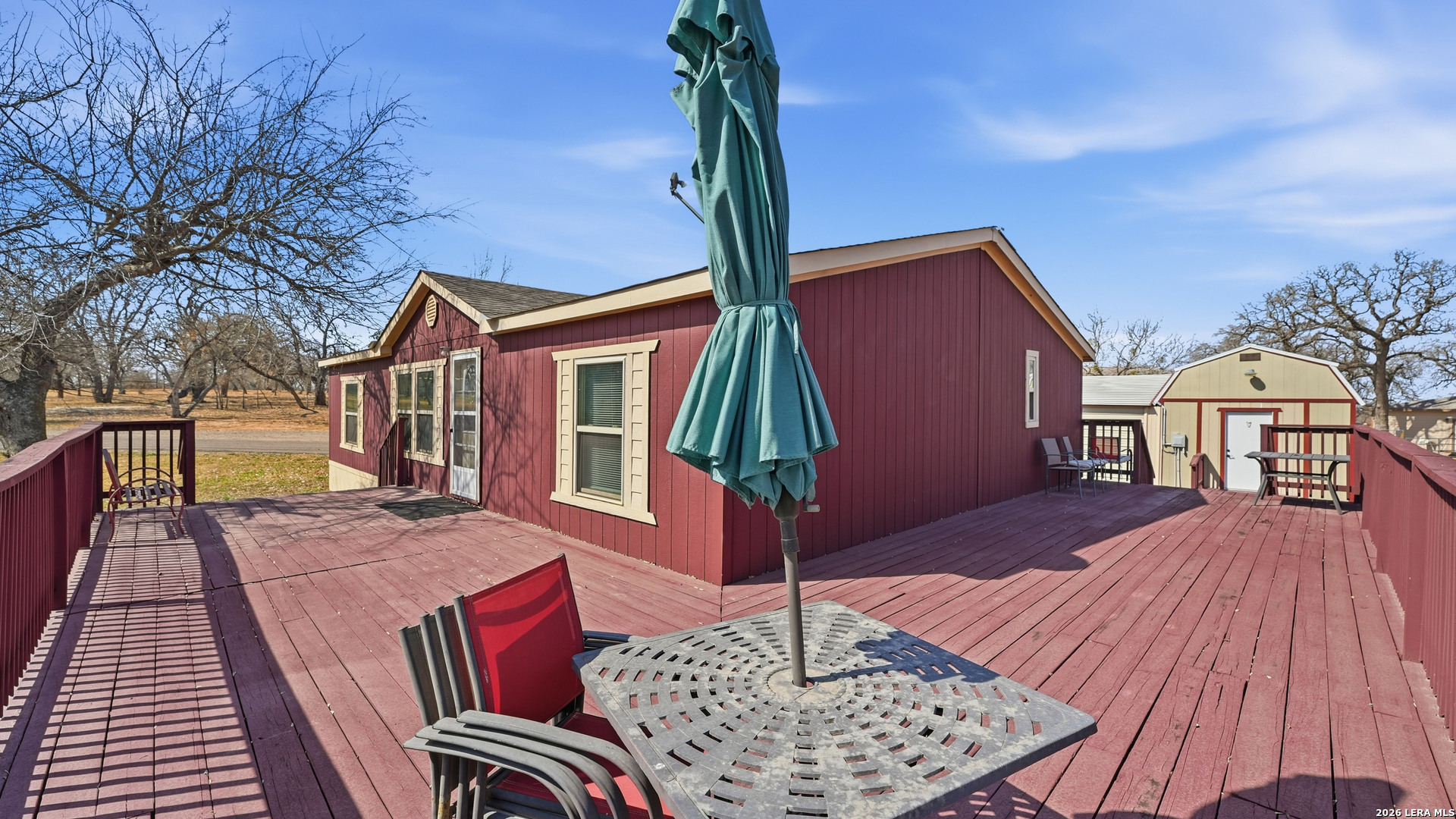 22071 Morin Road Von Ormy, TX 78073 - Photo 1 of 31 a backyard of a house with barbeque oven table and chairs