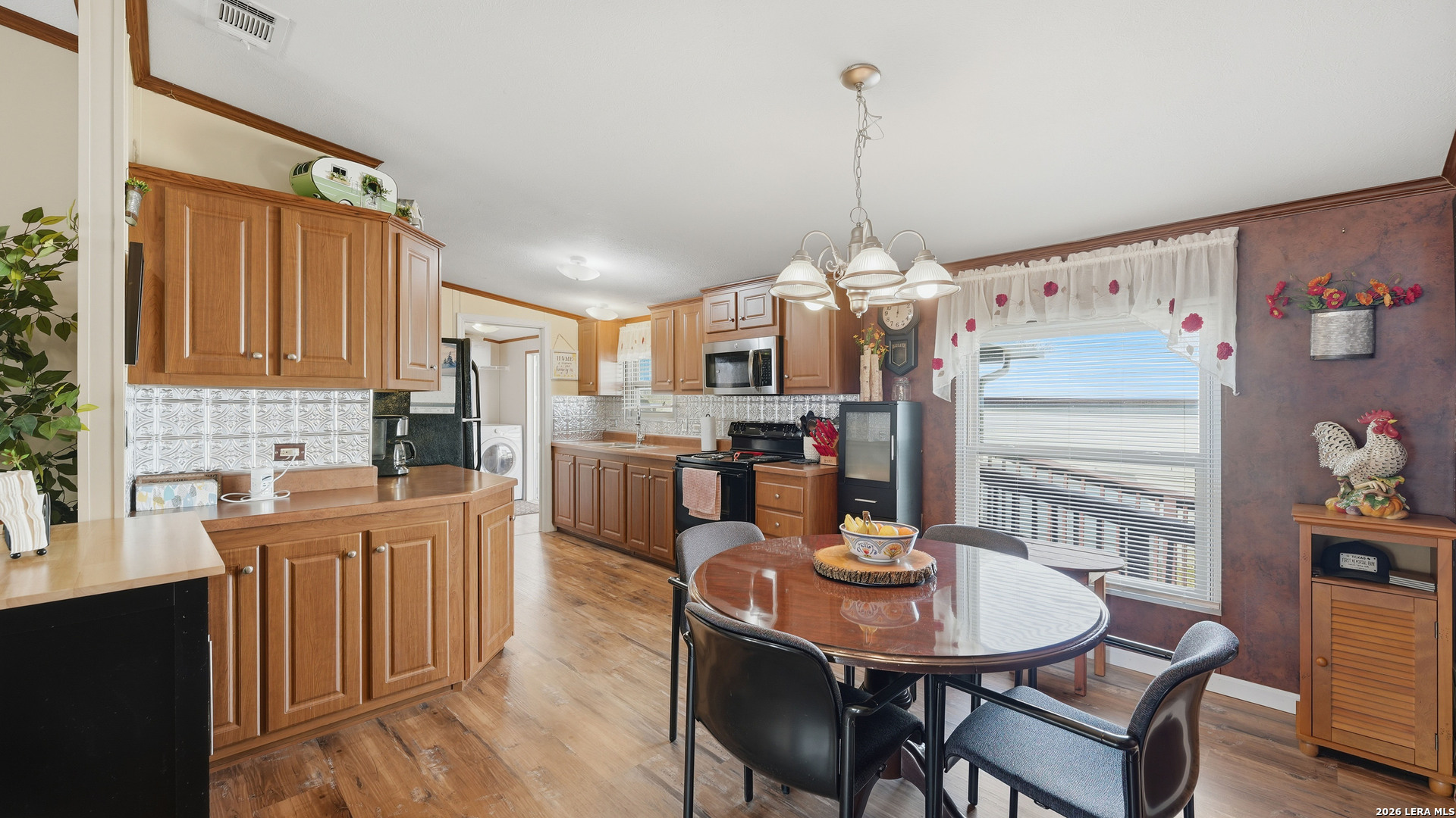 22071 Morin Road Von Ormy, TX 78073 - Photo 11 of 31 a view of a dining room with furniture window and wooden floor