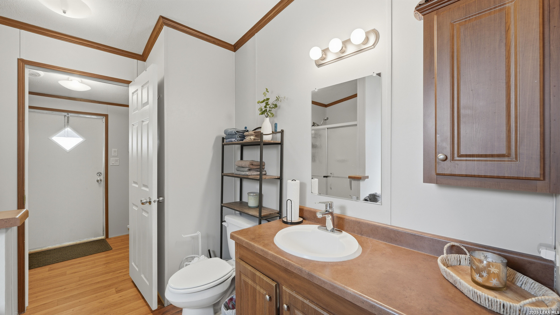 22071 Morin Road Von Ormy, TX 78073 - Photo 18 of 31 a bathroom with a granite countertop sink and a mirror with toilet