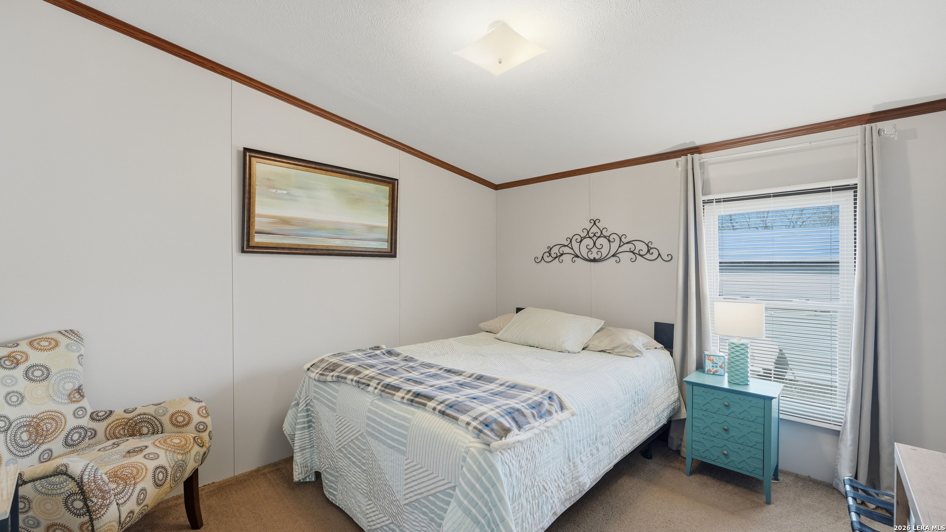 22071 Morin Road Von Ormy, TX 78073 - Photo 22 of 31 a bedroom with a bed and a painting on the wall