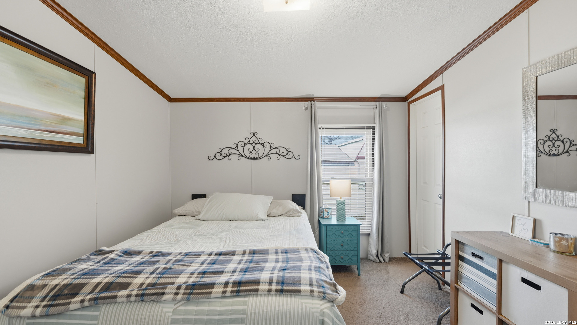 22071 Morin Road Von Ormy, TX 78073 - Photo 23 of 31 a bedroom with a large bed and a chandelier