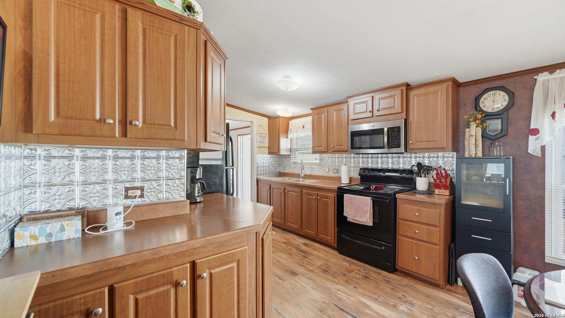 22071 Morin Road Von Ormy, TX 78073 - Photo 9 of 31 a kitchen with stainless steel appliances granite countertop a refrigerator sink and stove