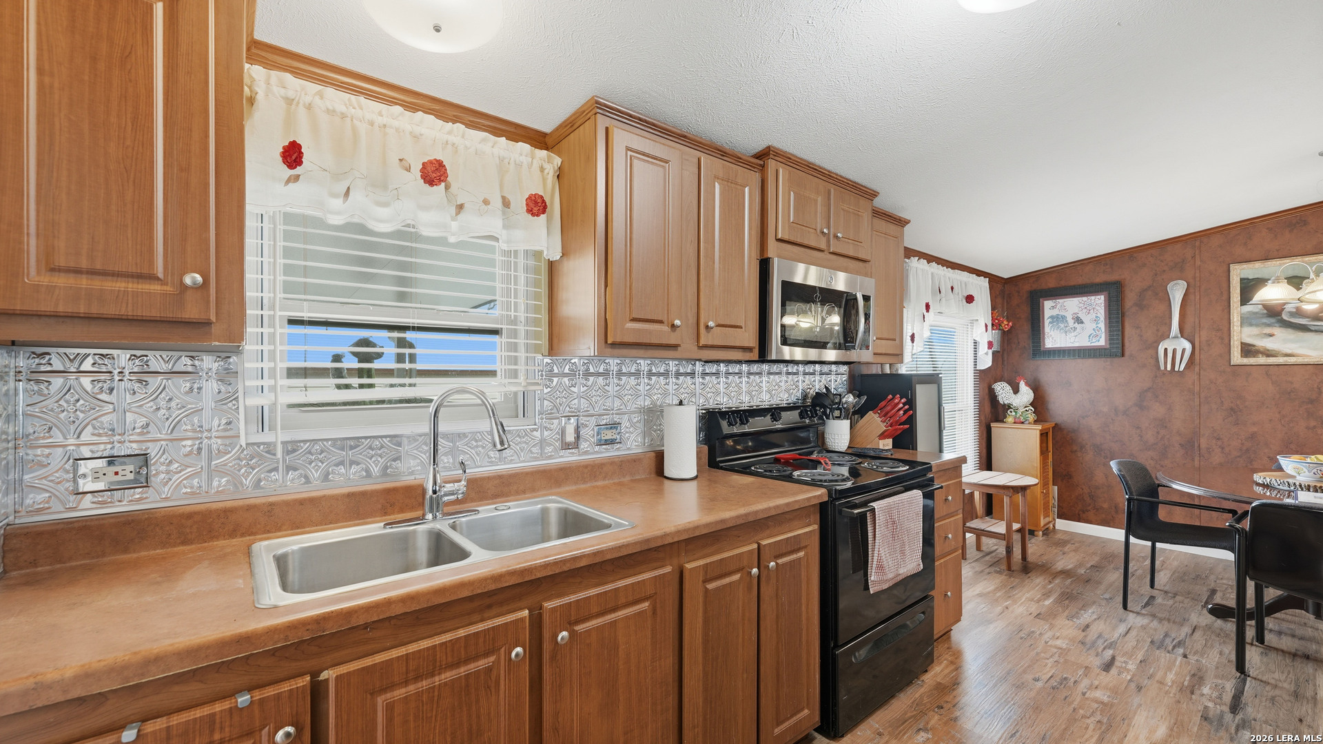 22071 Morin Road Von Ormy, TX 78073 - Photo 10 of 31 a kitchen that has a sink and a stove