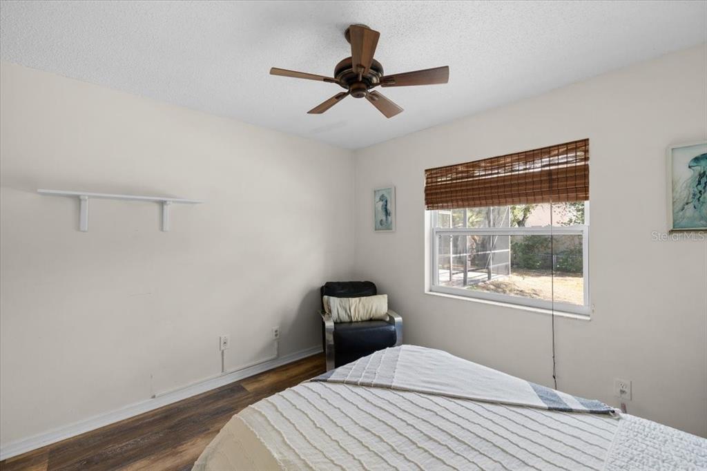 4498 Plumosa Street Spring Hill, FL 34607 - Photo 14 of 24 a bedroom with a bed and a window